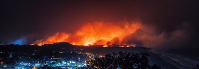 Wildfire on a hill behind a town